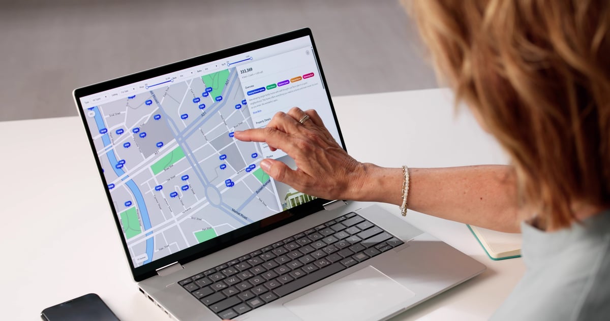 Woman Searches Online For Real Estate Properties On Her Computer. Senior Woman Uses Laptop To Locate Apartments